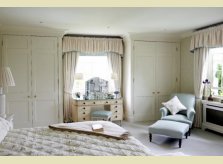 Painted bedroom scheme with built in wardrobes and matching radiator cover